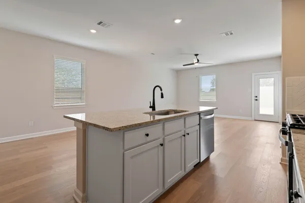 a kitchen with sink and cabinets