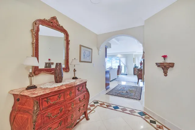 a bedroom with a large bed and a mirror