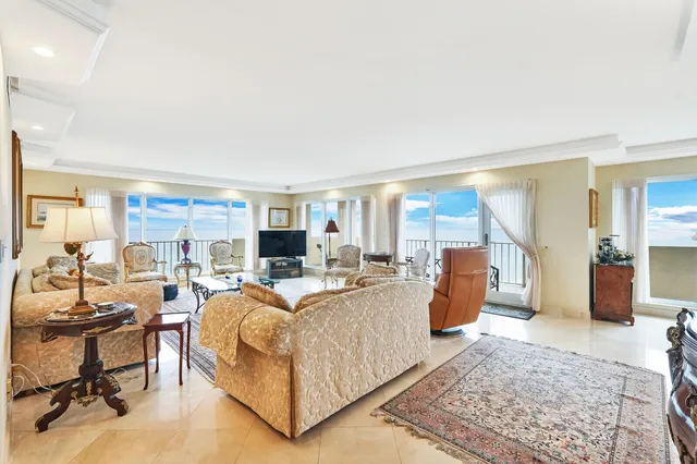 a living room with furniture wooden floor and a large window