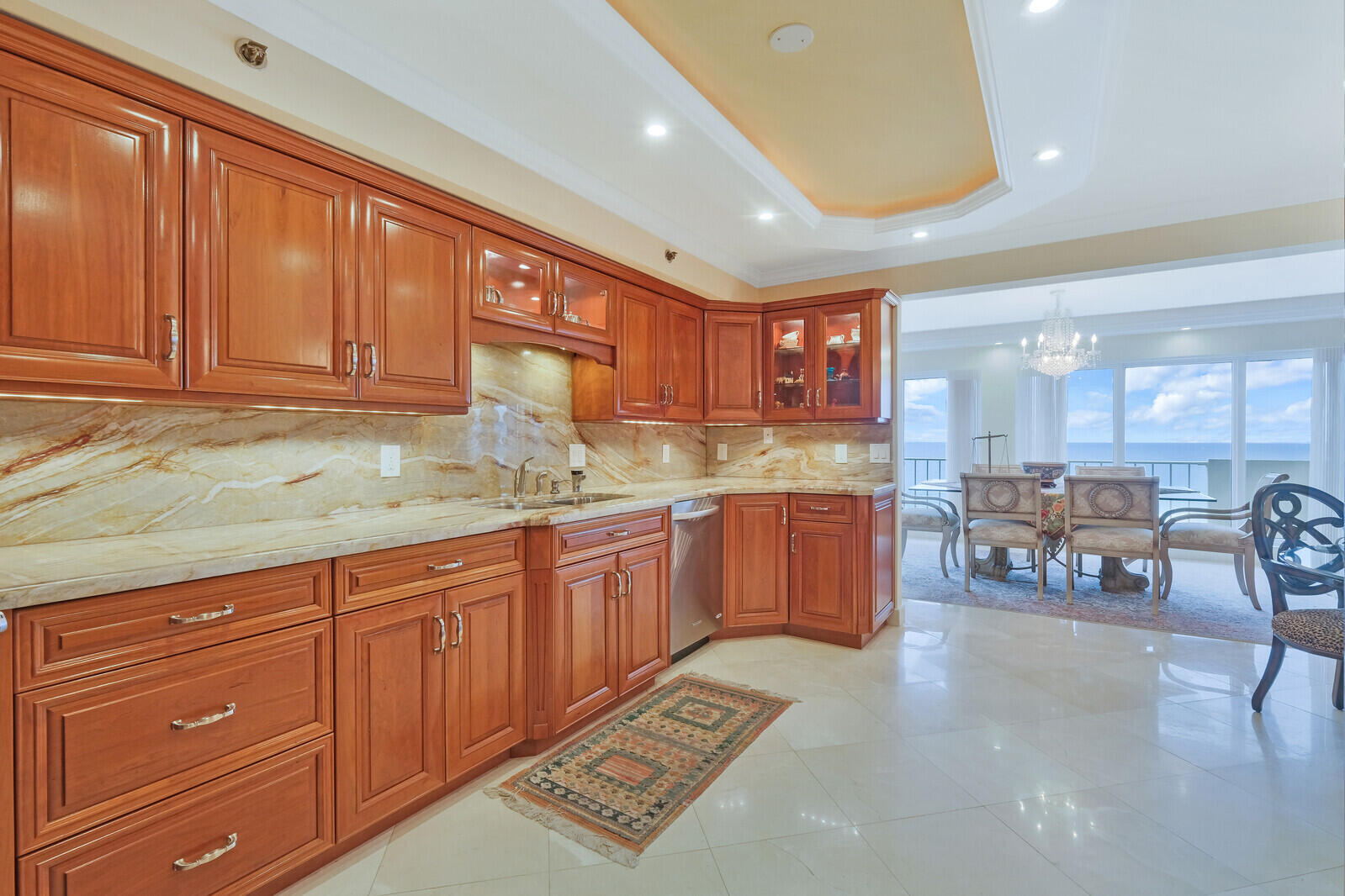 4001 North Ocean Boulevard, Unit B1201 Boca Raton, FL 33431 - Photo 19 of 42 a kitchen with granite countertop a sink cabinets and window
