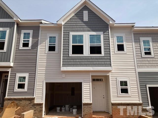 3413 Oak Pass Drive Raleigh, NC 27610 - Photo 1 of 11 a front view of a house with a balcony