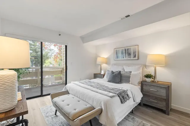 a bedroom with a bed and a lamp