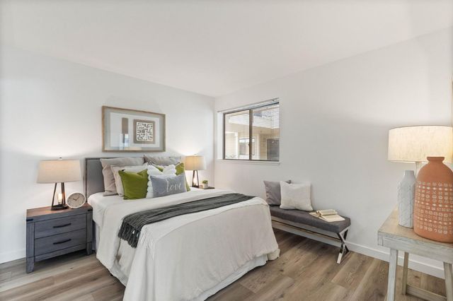 a bed room with a bed and a lamp