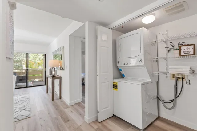a storage room with wooden floor washer and dryer