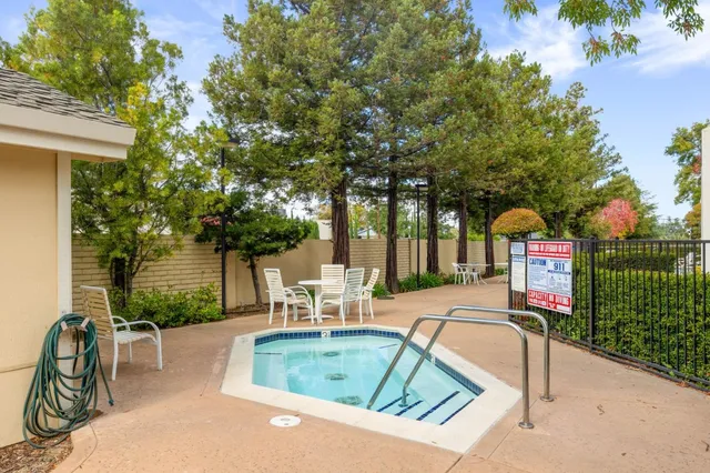 a view of a backyard with sitting area
