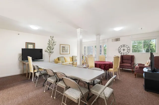 a kitchen with a sink a refrigerator a window and cabinets