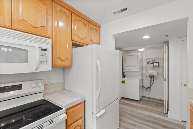 a kitchen with a refrigerator and a stove
