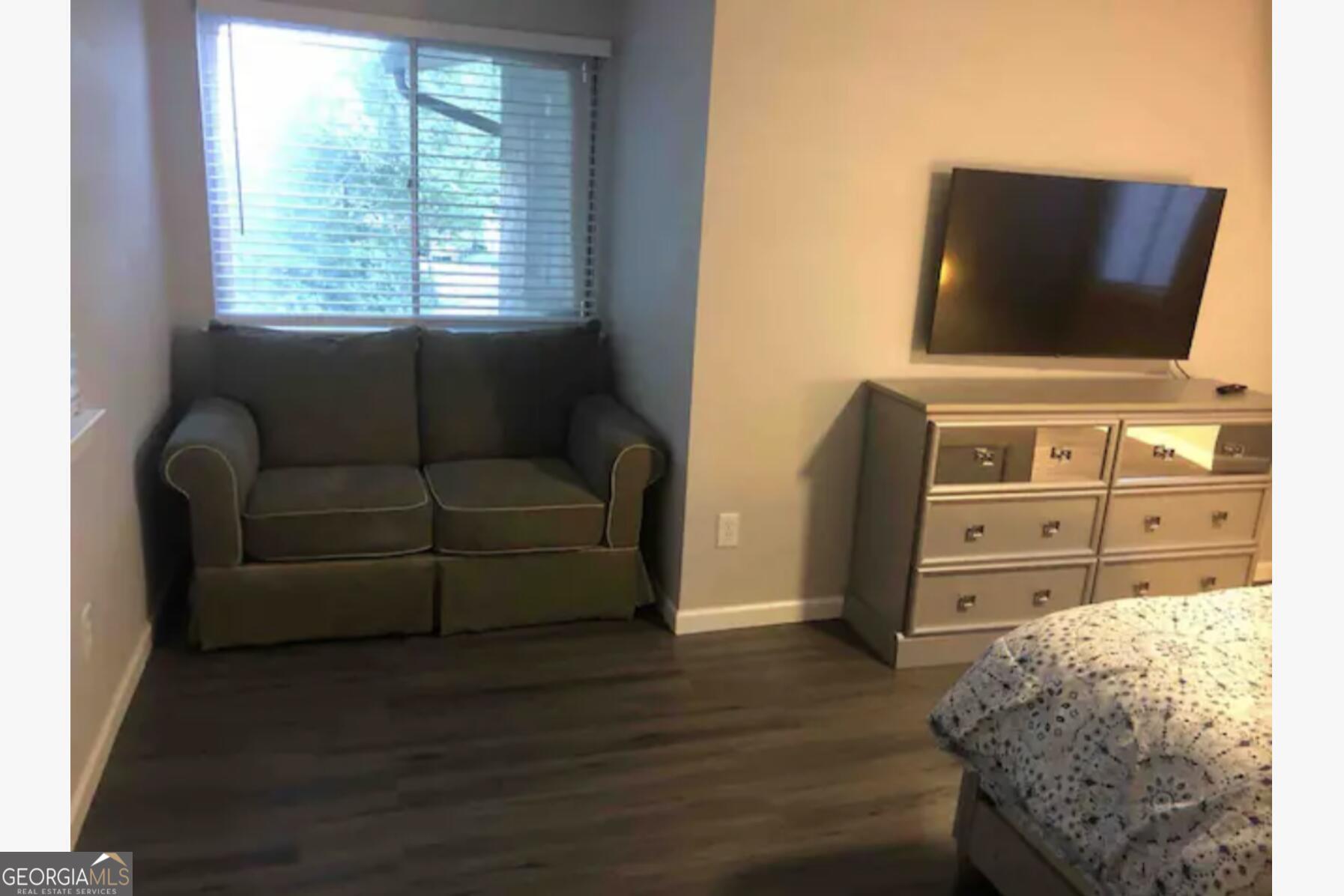 3834 Kensingwood Trace Decatur, GA 30032 - Photo 11 of 26 a living room with furniture and a flat screen tv
