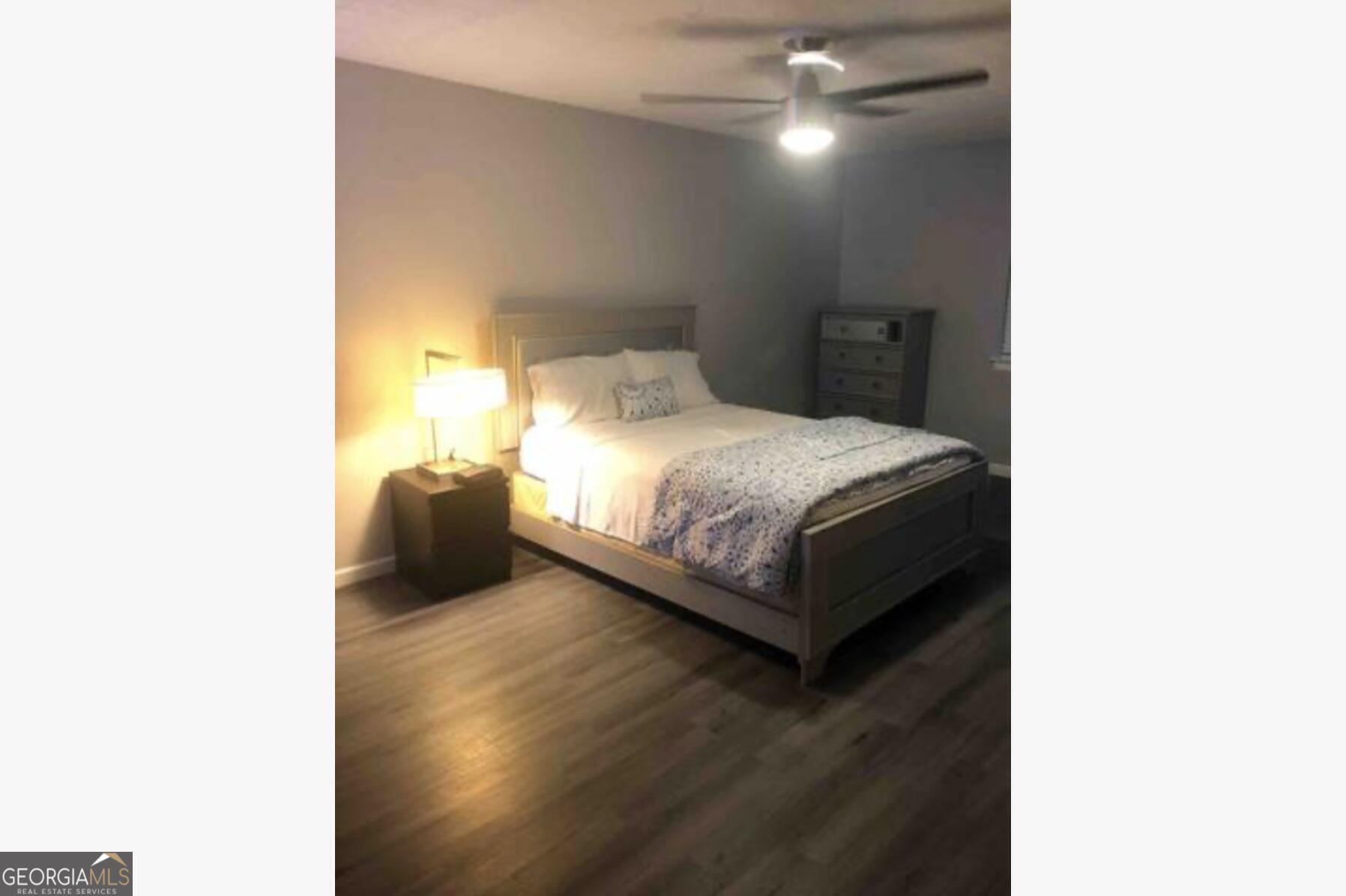 3834 Kensingwood Trace Decatur, GA 30032 - Photo 14 of 26 a bedroom with a bed and a night stand