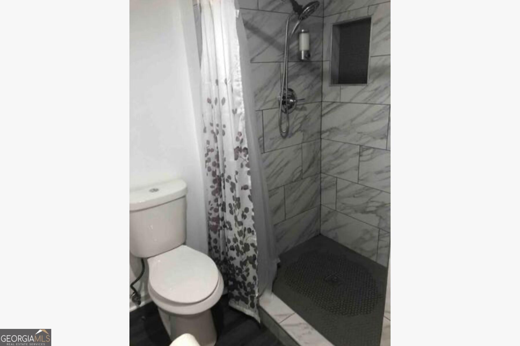 3834 Kensingwood Trace Decatur, GA 30032 - Photo 15 of 26 a bathroom with a toilet and a shower