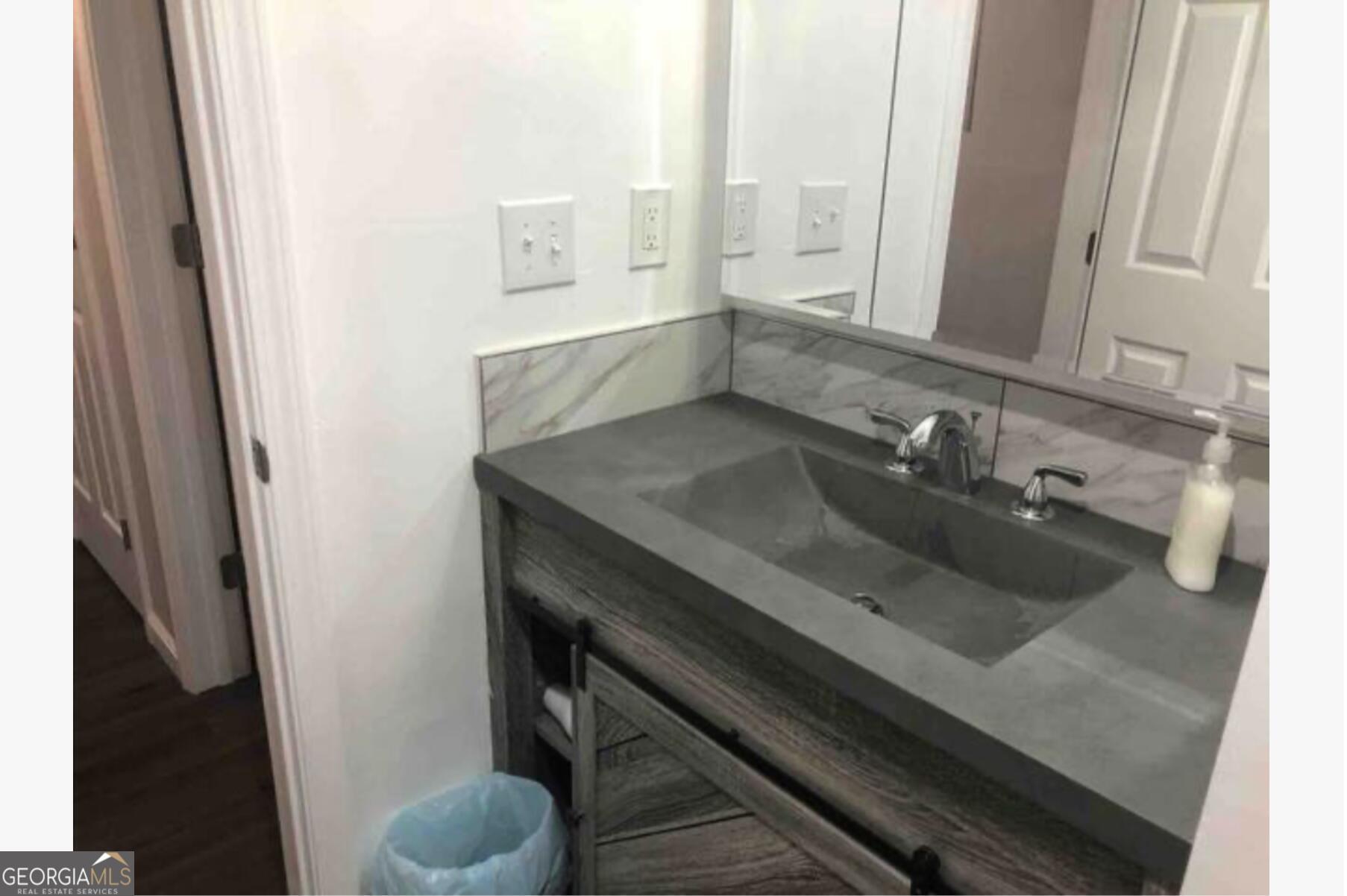 3834 Kensingwood Trace Decatur, GA 30032 - Photo 16 of 26 a bathroom with a sink and a mirror