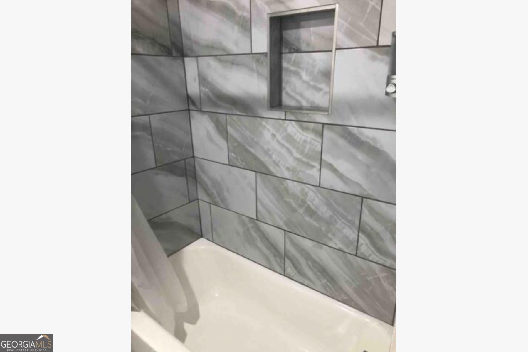 3834 Kensingwood Trace Decatur, GA 30032 - Photo 17 of 26 a bathroom with a bathtub