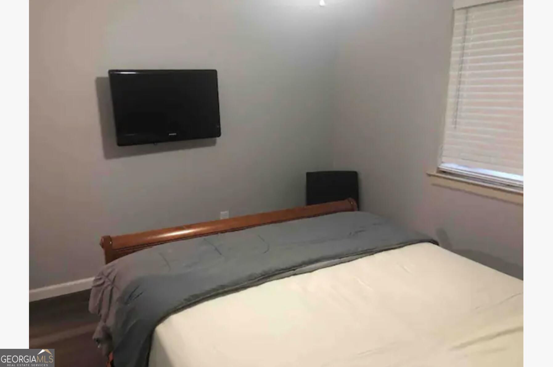 3834 Kensingwood Trace Decatur, GA 30032 - Photo 18 of 26 a bed room with a bed and a television