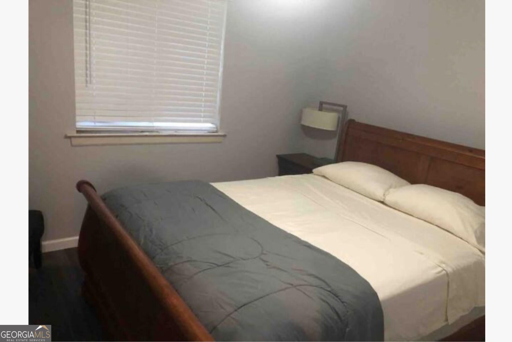 3834 Kensingwood Trace Decatur, GA 30032 - Photo 19 of 26 a bedroom with a bed and a window