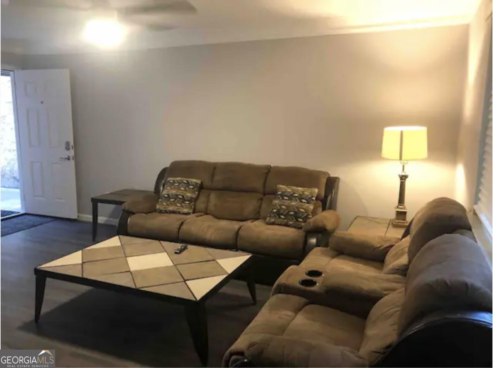 3834 Kensingwood Trace Decatur, GA 30032 - Photo 2 of 26 a living room with a couch and a wooden floor