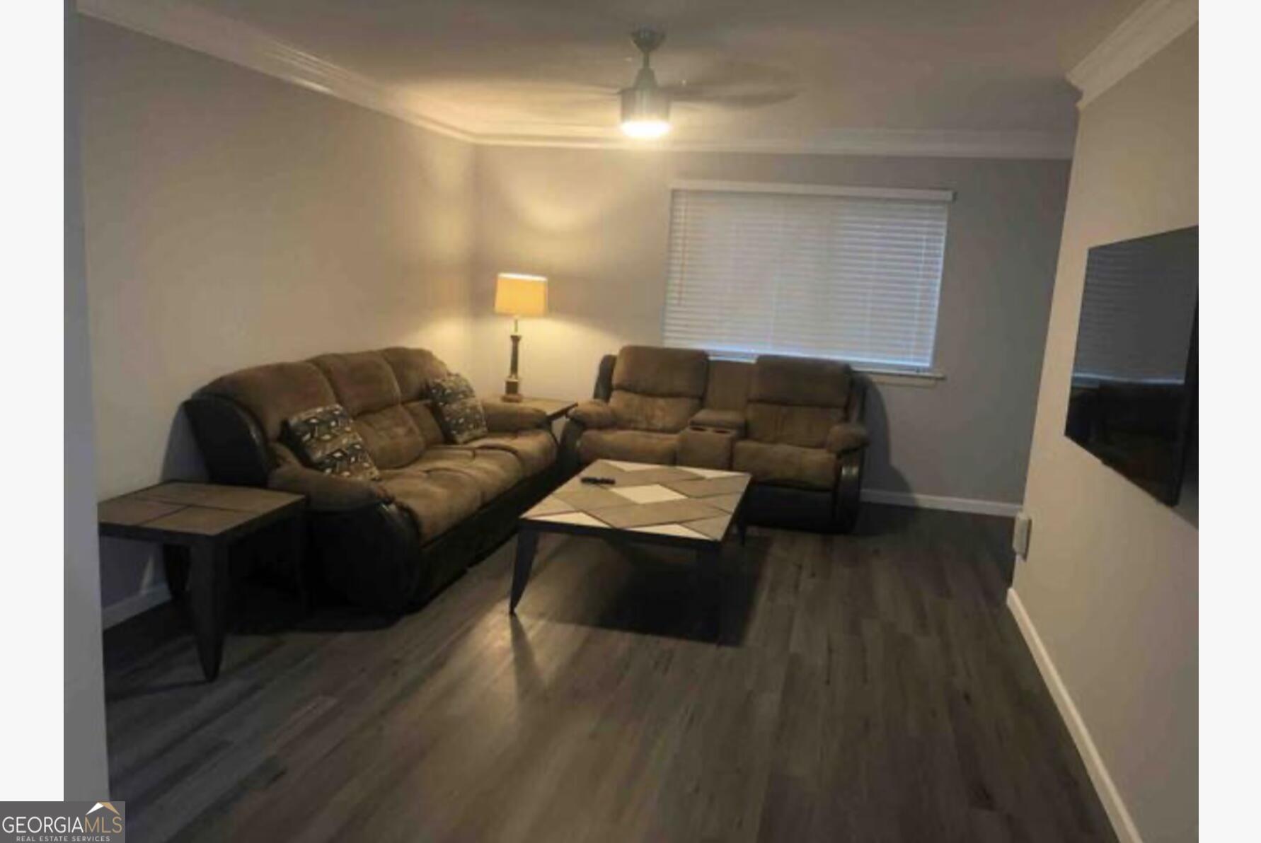 3834 Kensingwood Trace Decatur, GA 30032 - Photo 26 of 26 a living room with furniture and a flat screen tv