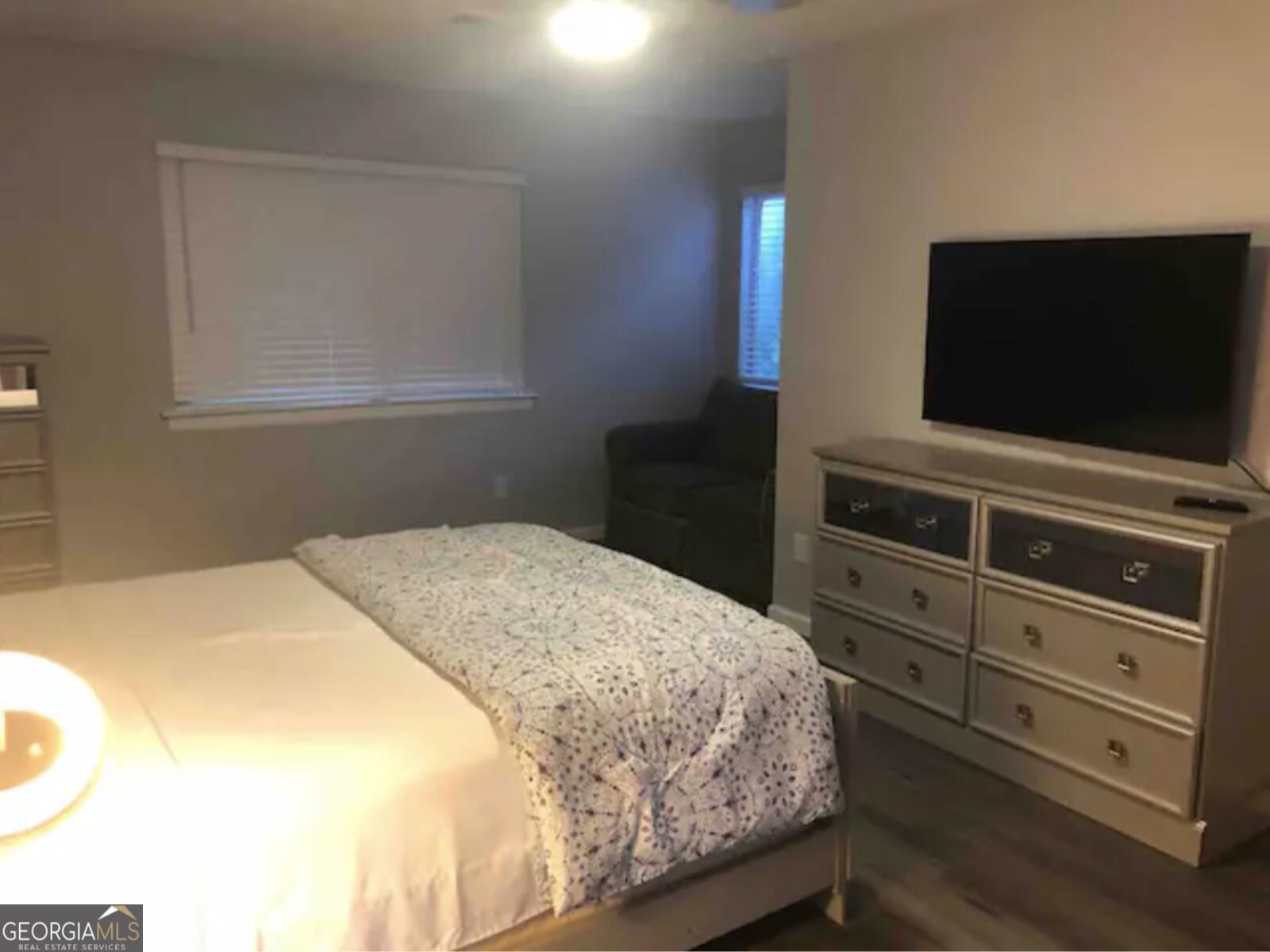 3834 Kensingwood Trace Decatur, GA 30032 - Photo 3 of 26 a bedroom with a bed and a flat screen tv
