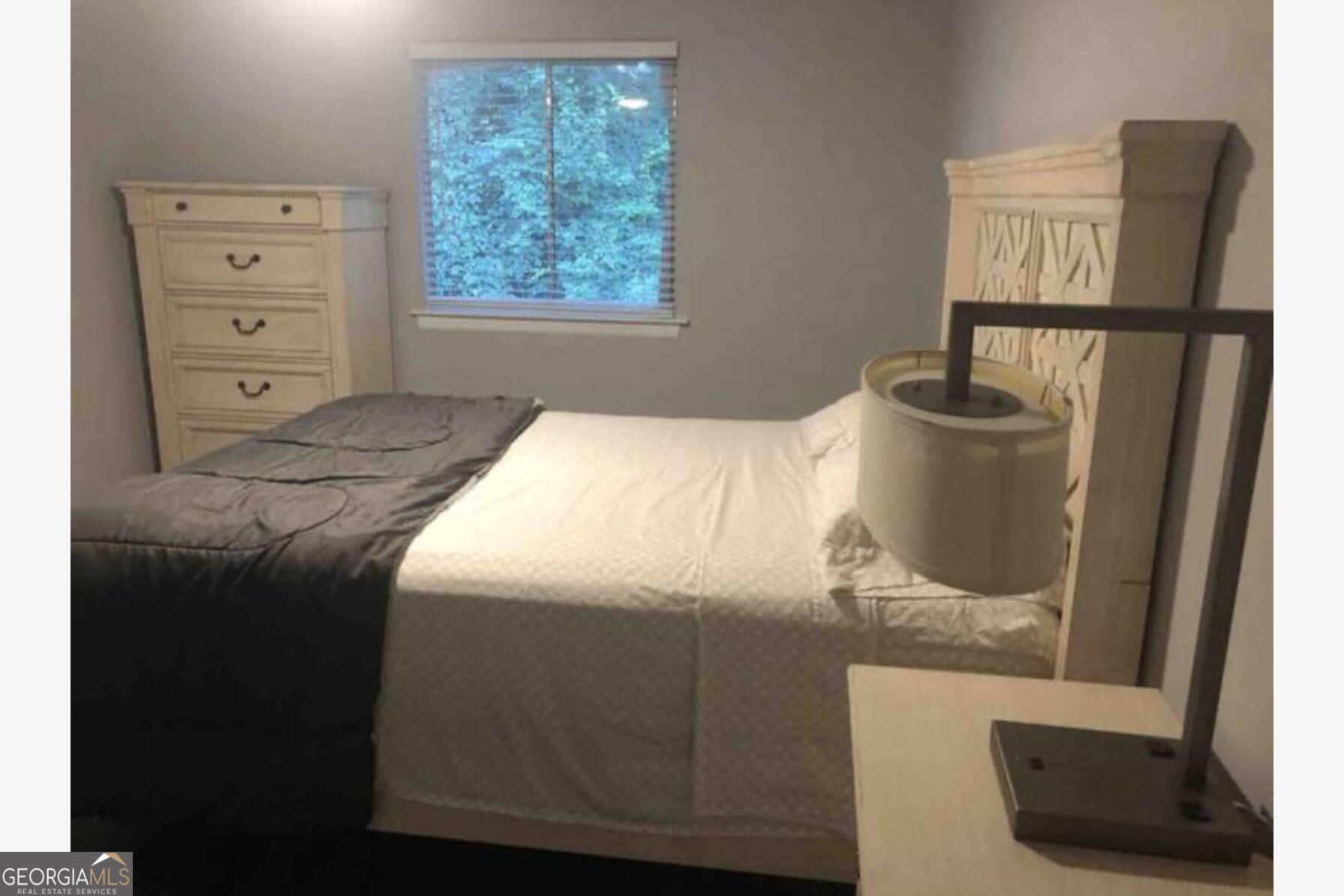 3834 Kensingwood Trace Decatur, GA 30032 - Photo 7 of 26 a bedroom with a bed and a mirror