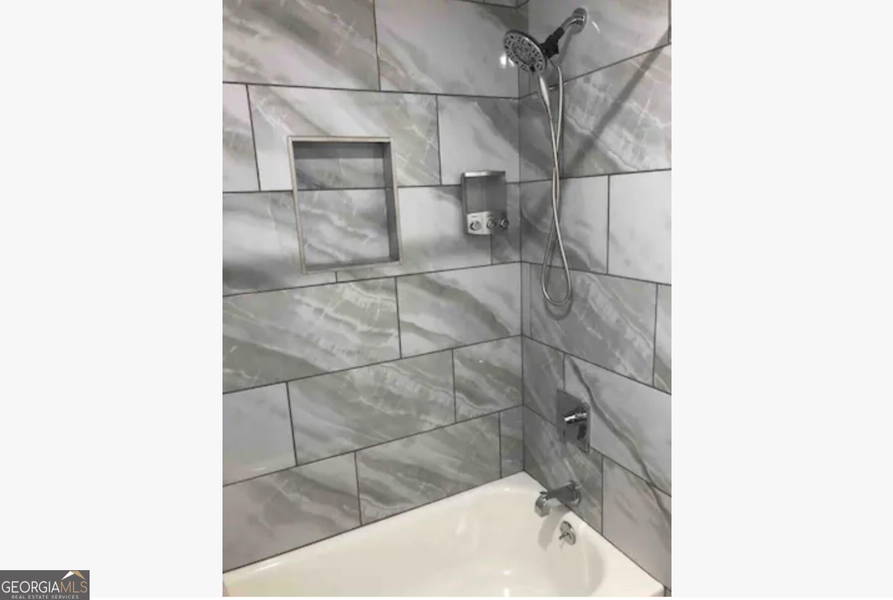 3834 Kensingwood Trace Decatur, GA 30032 - Photo 9 of 26 a bathroom with a bathtub and shower