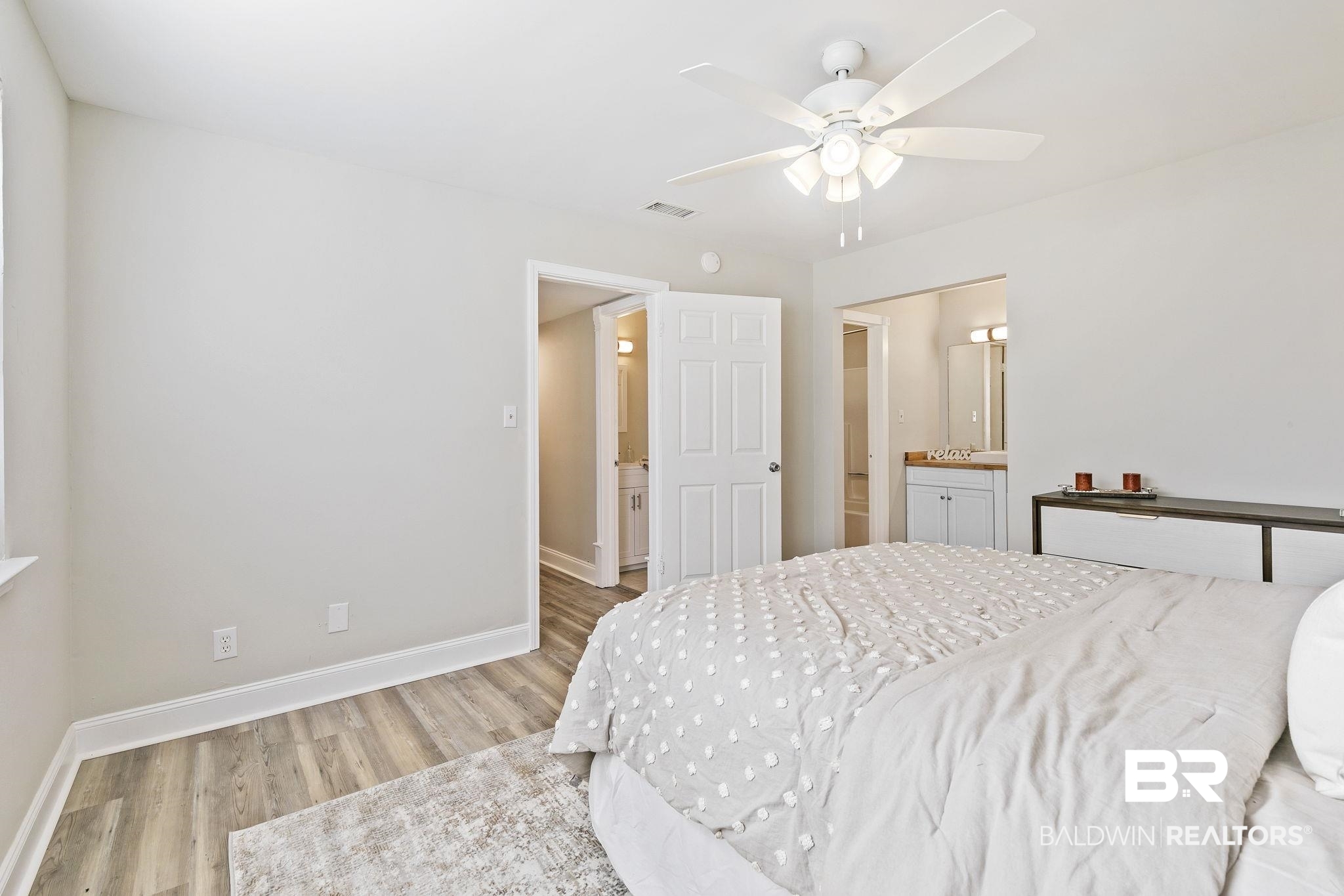 110 5th Street, Unit C103 Daphne, AL 36526 - Photo 32 of 46 Bedroom featuring ceiling fan, connected bathroom, and light hardwood / wood-style floors