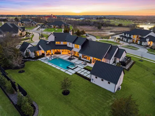 an aerial view of a house with a big yard