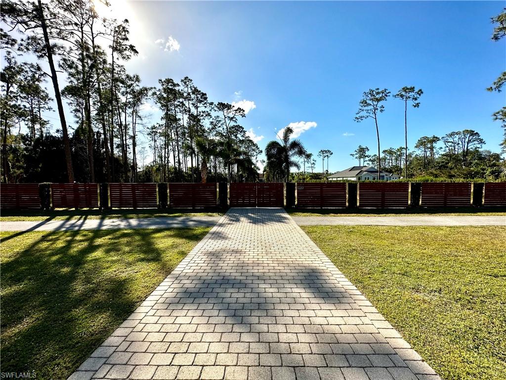 1391 Oakes Boulevard Naples, FL 34119 - Photo 5 of 43 View at the gate from the main street