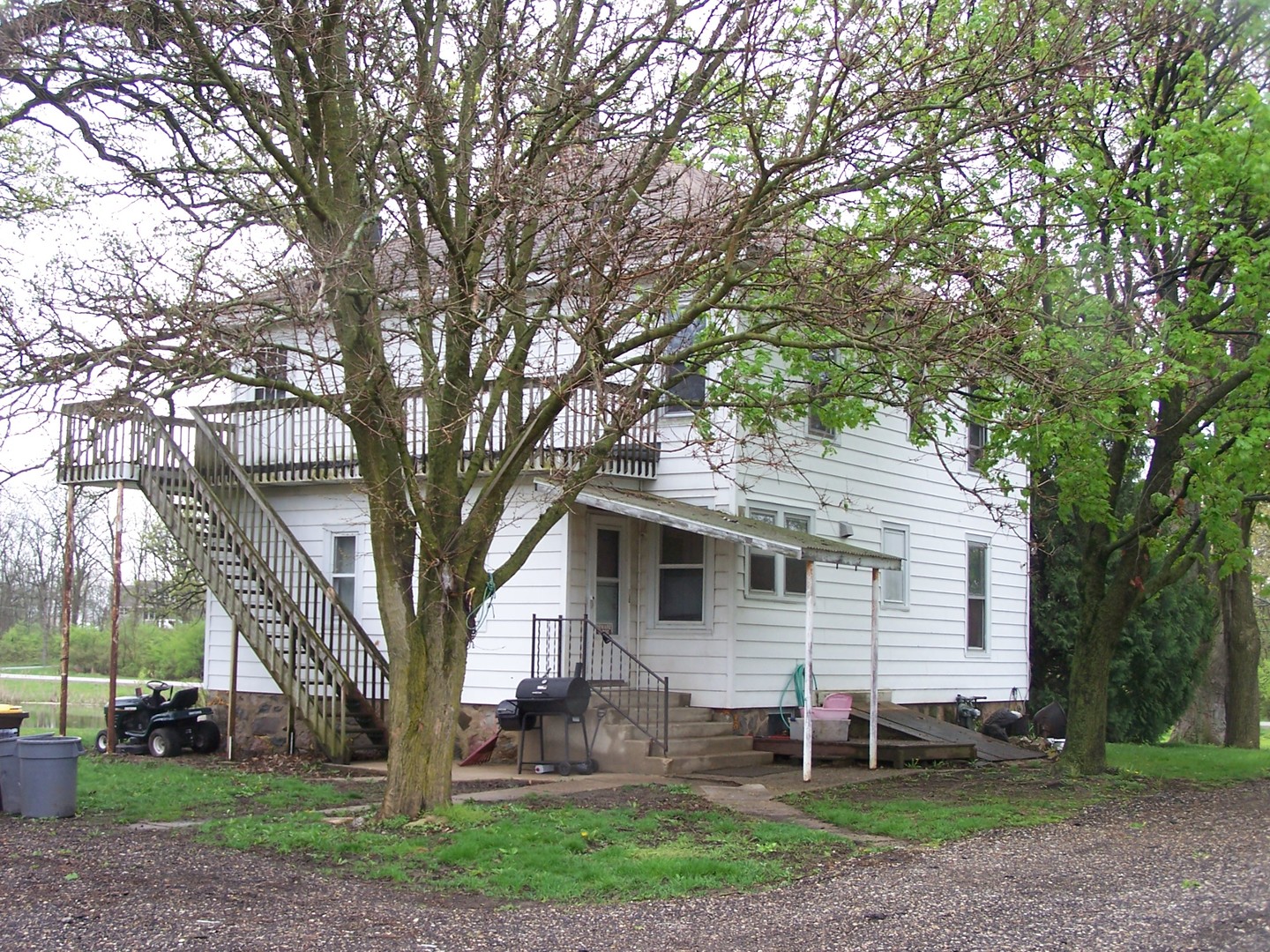 13810 Davis Road Woodstock, IL 60098 - Photo 4 of 13 front view of a house with a yard and an trees