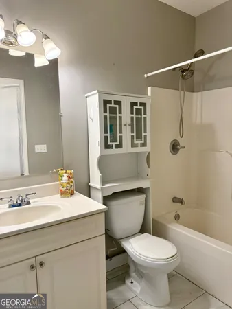 a bathroom with a sink toilet a mirror and shower