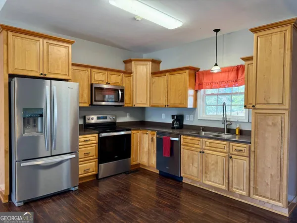 a kitchen with stainless steel appliances a stove a refrigerator and a sink