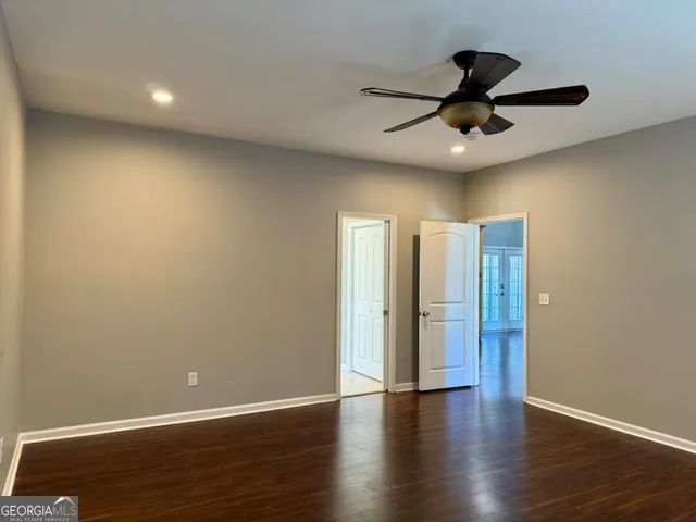 a view of an empty room with wooden floor