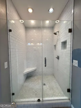 a bathroom with a glass shower door