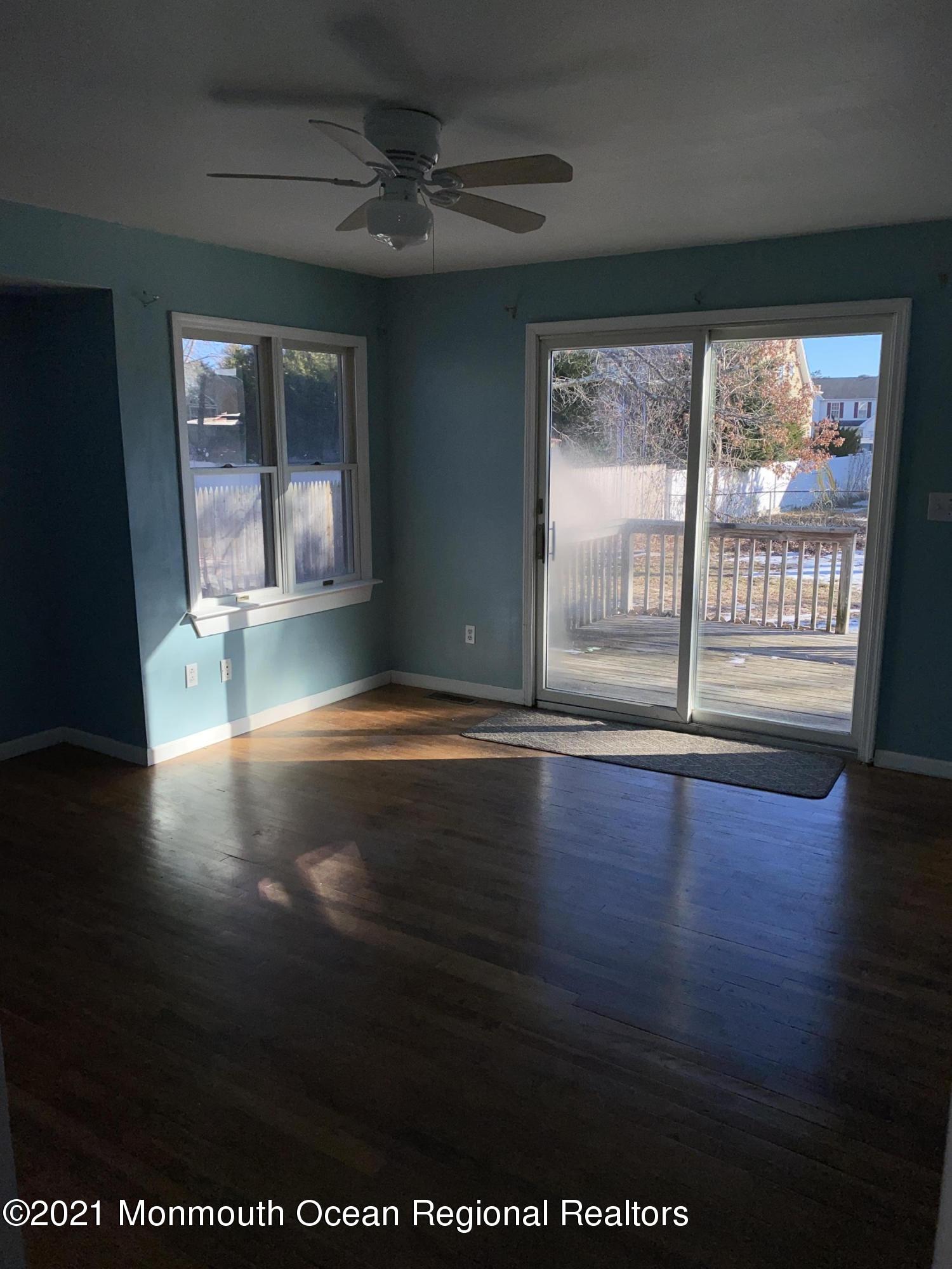 295 Western Boulevard Bayville, NJ 08721 - Photo 7 of 11 a view of empty room with wooden floor and fan