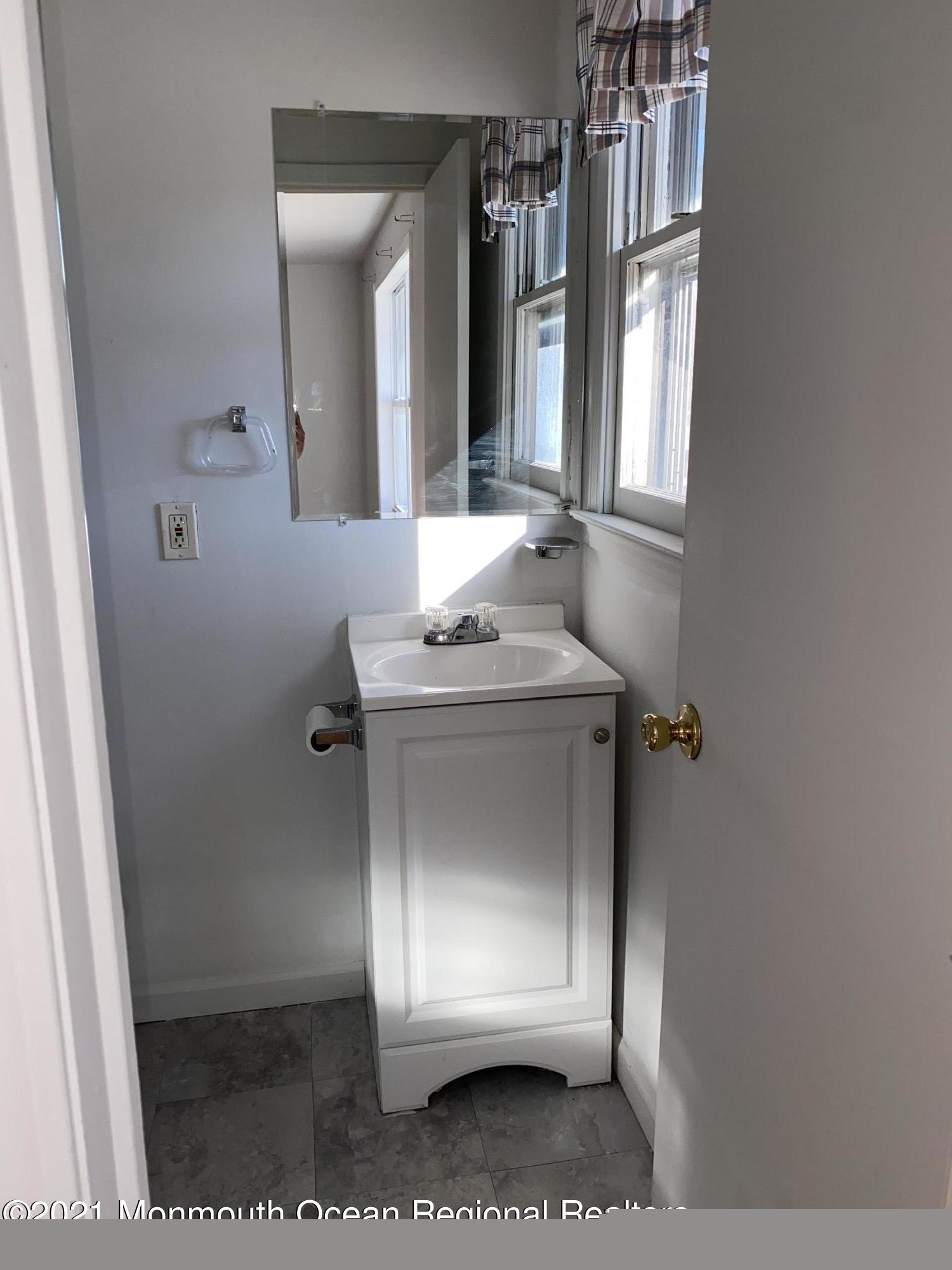 295 Western Boulevard Bayville, NJ 08721 - Photo 9 of 11 a bathroom with a sink and a mirror