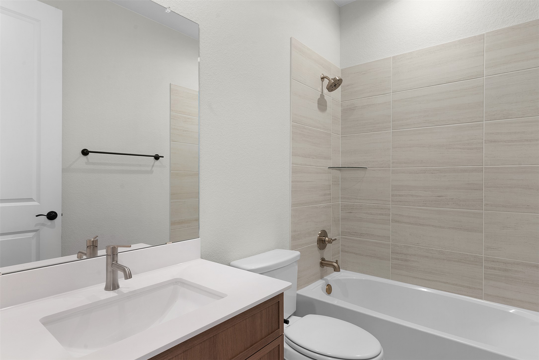 1121 Pansy Trail Georgetown, TX 78628 - Photo 3 of 25 Bathroom with vanity, tub / shower combination, and a textured wall
