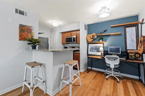 a workspace with furniture wooden floor and windows