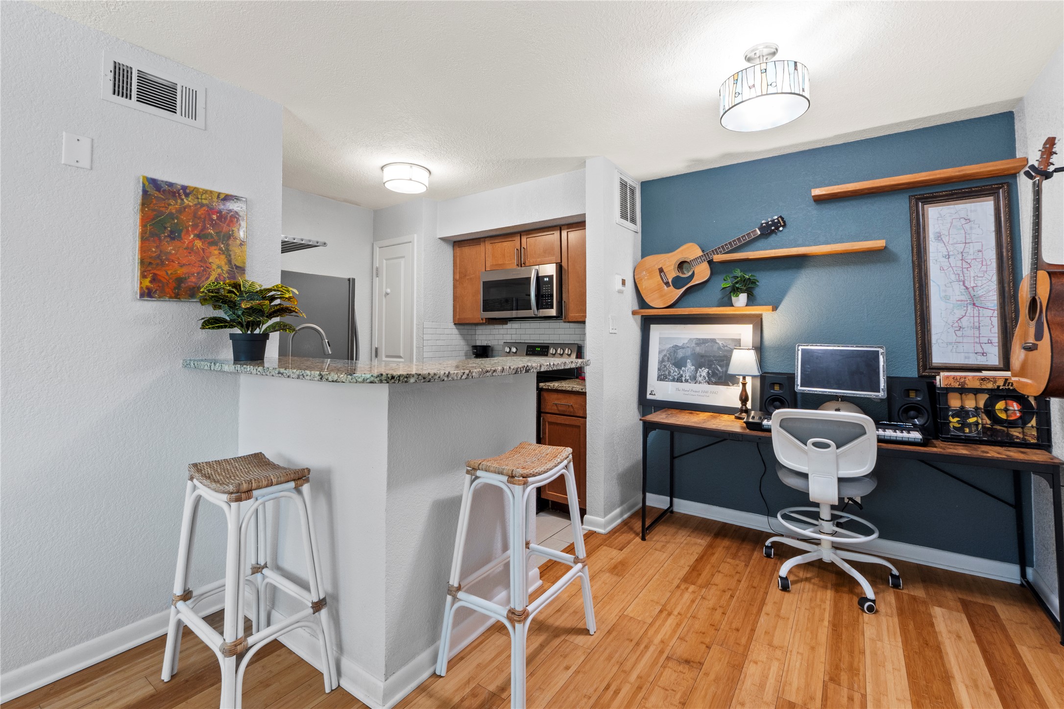 3204 Menchaca Road, Unit 305 Austin, TX 78704 - Photo 4 of 25 Grab a bite at the breakfast bar before you head out for your day. Notice the gleaming bamboo flooring!