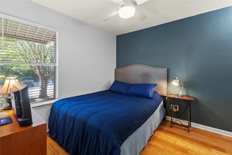 a bed sitting in a bedroom next to a window