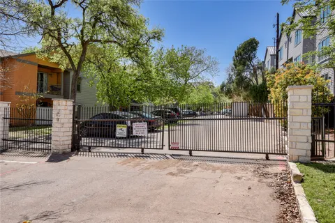 a view of a park with iron fence