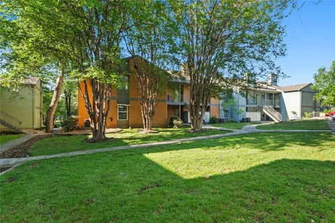 a view of a house with a backyard