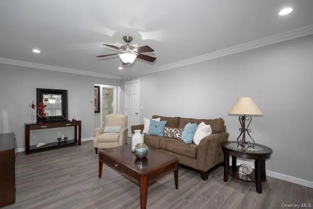 a living room with furniture a ceiling fan and a rug