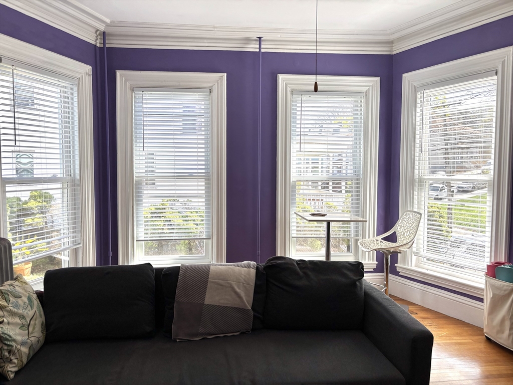 170 Poplar Street, Unit 1 Boston, MA 02131 - Photo 8 of 20 a living room with furniture and windows