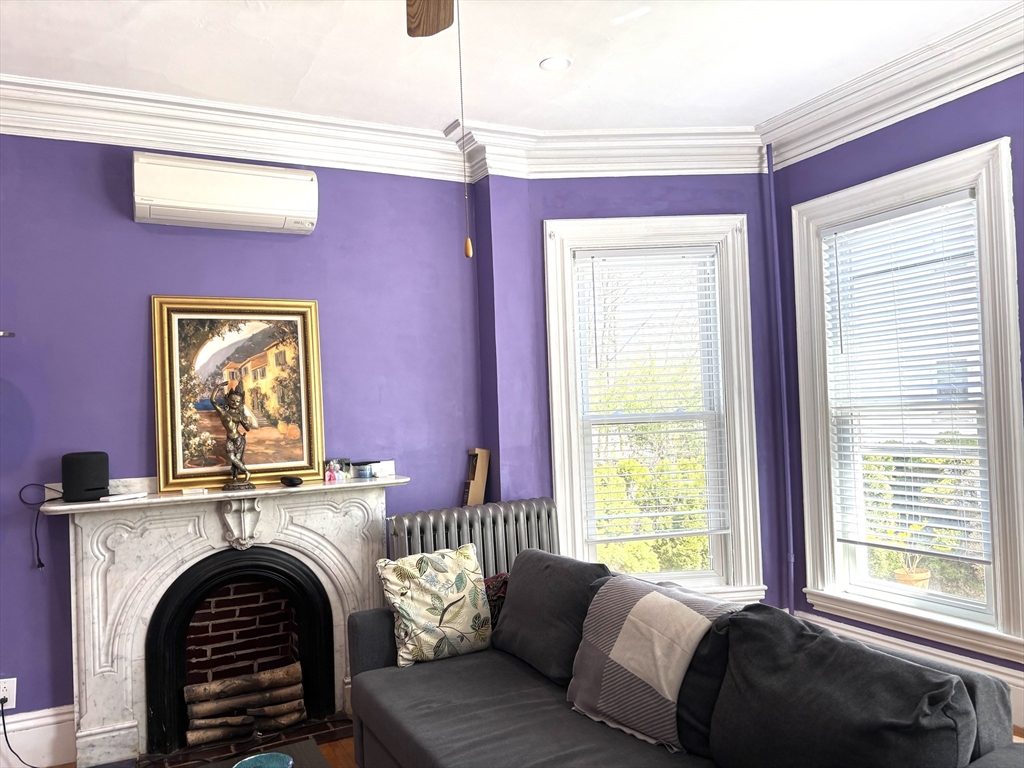 170 Poplar Street, Unit 1 Boston, MA 02131 - Photo 9 of 20 a bed room with a bed and a fireplace