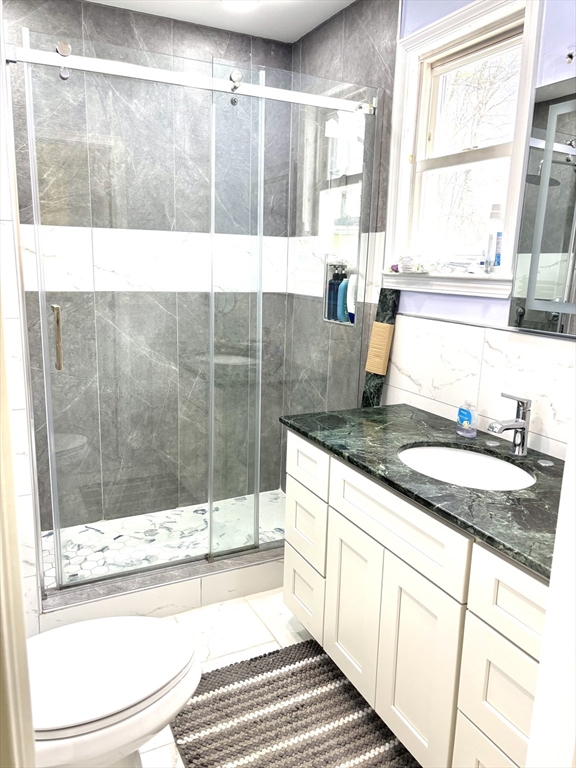 170 Poplar Street, Unit 1 Boston, MA 02131 - Photo 10 of 20 a bathroom with a granite countertop sink and a bathtub