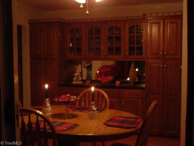 2514 Shady Grove Church Road Staley, NC 27355 - Photo 6 of 9 Other. This view of Breakfast room taken from the screened porch in the evening highlights the wonderful built-in cabinetry.