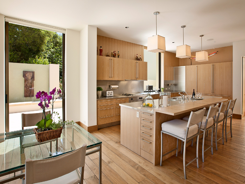 356 Woodley Road Montecito, CA 93108 - Photo 8 of 17 a kitchen with granite countertop a table chairs stove and wooden floor