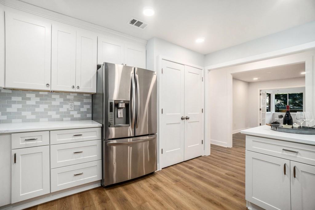 46 La Rue Place Northwest Atlanta, GA 30327 - Photo 13 of 28 a kitchen with white cabinets and stainless steel appliances