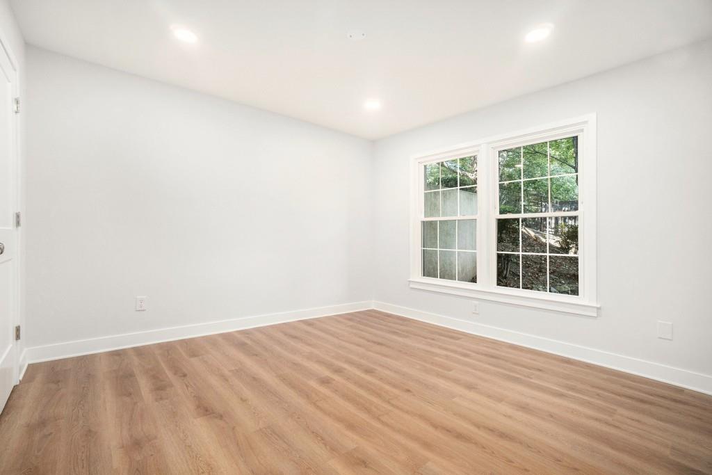 46 La Rue Place Northwest Atlanta, GA 30327 - Photo 15 of 28 an empty room with wooden floor and windows