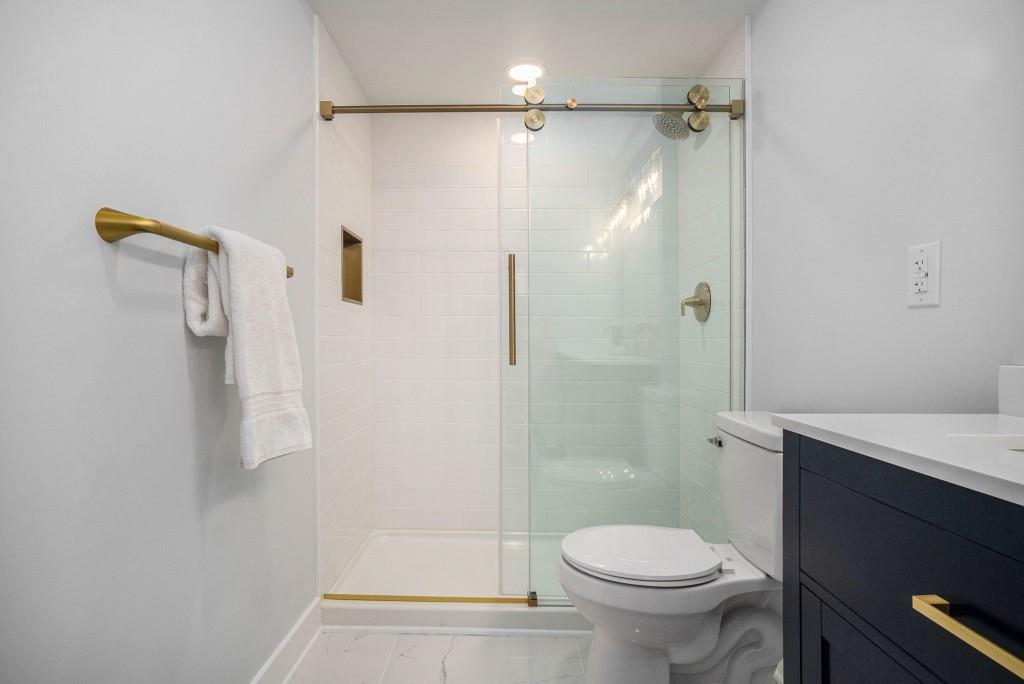46 La Rue Place Northwest Atlanta, GA 30327 - Photo 17 of 28 a bathroom with a shower and a toilet