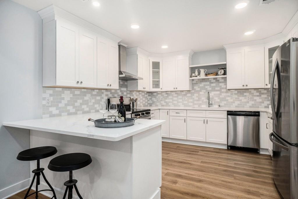 46 La Rue Place Northwest Atlanta, GA 30327 - Photo 2 of 28 a kitchen with stainless steel appliances granite countertop a sink stove and cabinets