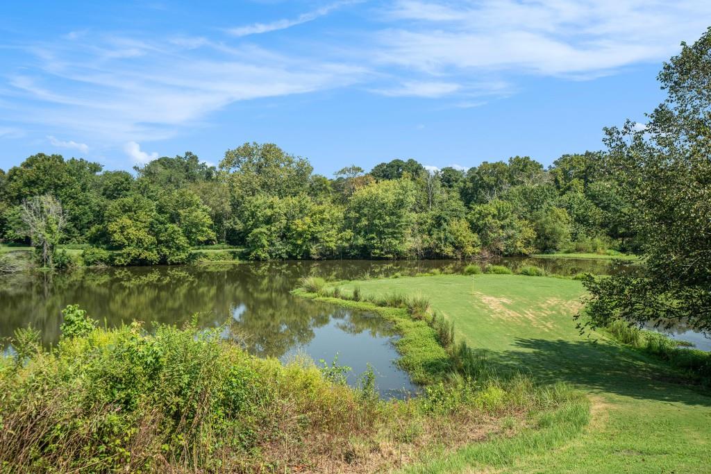 46 La Rue Place Northwest Atlanta, GA 30327 - Photo 22 of 28 a view of a lake with a yard
